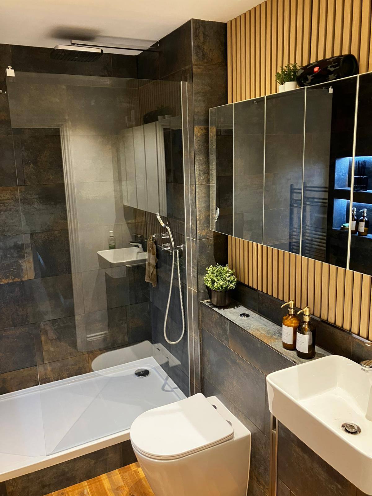 Dark bathroom with decorative wood slat wall