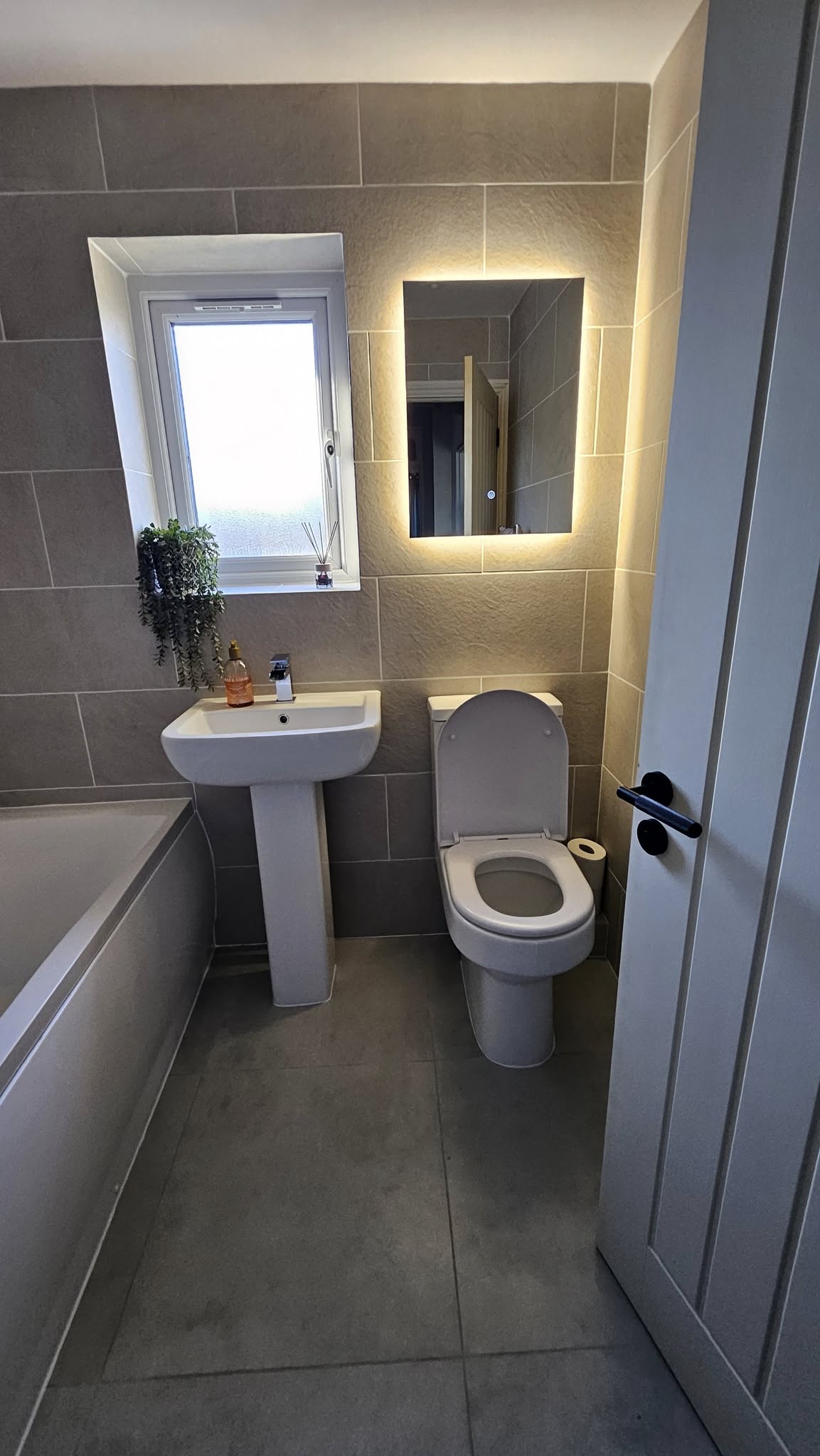 After: Modern grey bathroom with LED mirror
