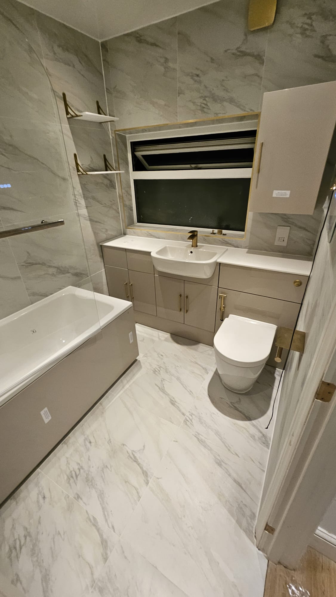 After: Marble bathroom with gold fixtures