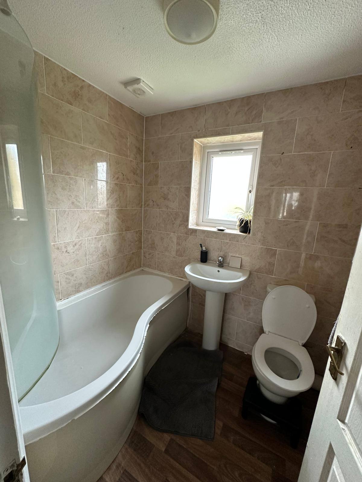 Before: Dated beige bathroom