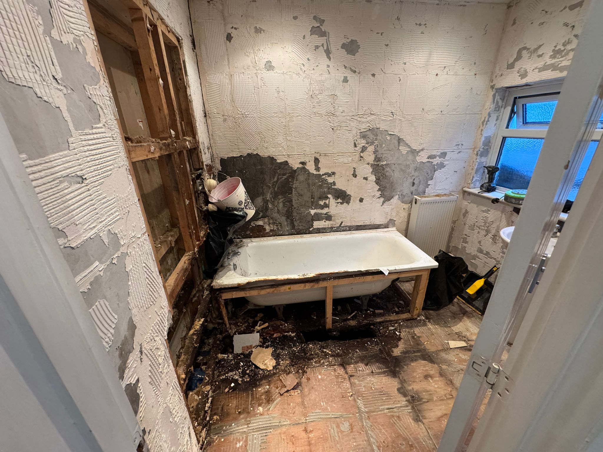 Before: Stripped bathroom